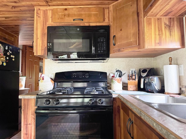 29156 State Highway 47, Aitkin, MN 56431 - kitchen with black appliances, brown cabinets, light countertops, and wood ceiling