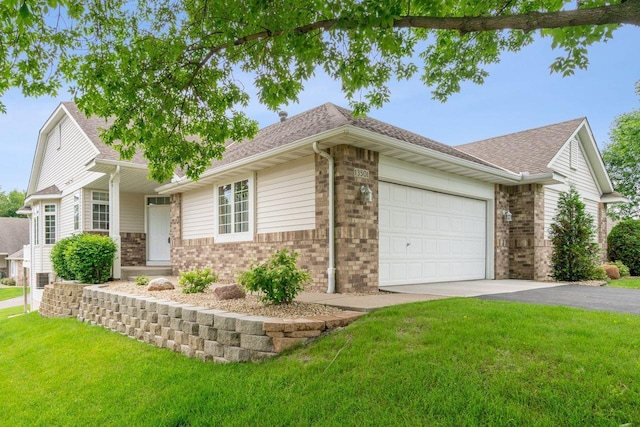 13501 96th Pl N, Maple Grove, MN 55369 - single story home with asphalt driveway, an attached garage, brick siding, a front lawn, and a shingled roof