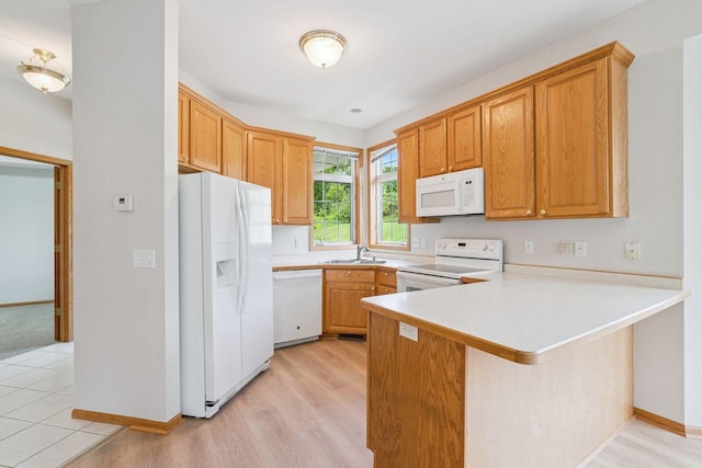 13501 96th Pl N, Maple Grove, MN 55369 - kitchen with white appliances, a peninsula, light countertops, and light wood-style floors