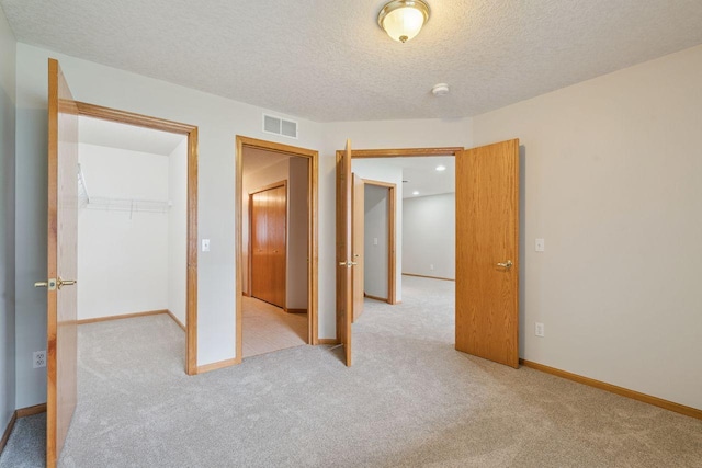 13501 96th Pl N, Maple Grove, MN 55369 - unfurnished bedroom featuring carpet flooring, a textured ceiling, and a closet