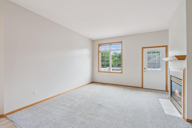 13501 96th Pl N, Maple Grove, MN 55369 - unfurnished living room featuring a tile fireplace and light colored carpet