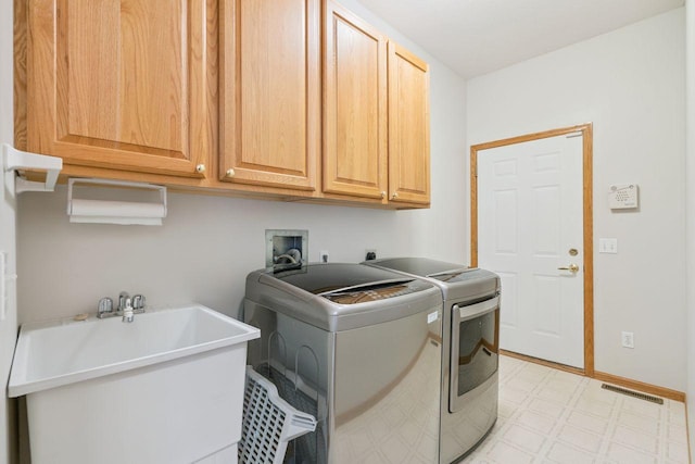13501 96th Pl N, Maple Grove, MN 55369 - laundry room with light flooring, cabinet space, and independent washer and dryer