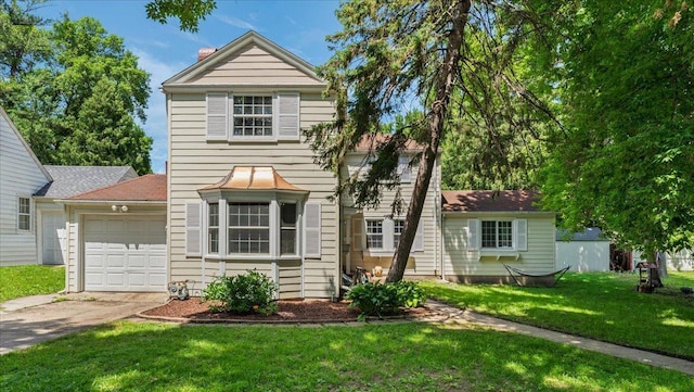918 Trott Ave SW, Willmar, MN 56201 - traditional-style house featuring an attached garage, concrete driveway, a front lawn, and a chimney
