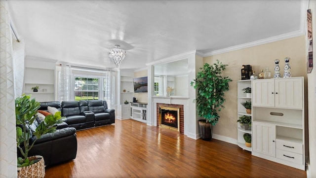 918 Trott Ave SW, Willmar, MN 56201 - living area featuring ornamental molding, wood finished floors, built in features, a brick fireplace, and a chandelier