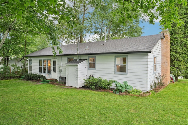 1671 Little Butternut Lake Ln, Luck, WI 54853 - back of house featuring a yard, a shingled roof, and a chimney