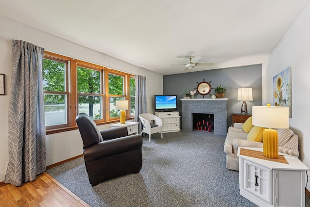 1671 Little Butternut Lake Ln, Luck, WI 54853 - living room featuring ceiling fan, a brick fireplace, and wood finished floors