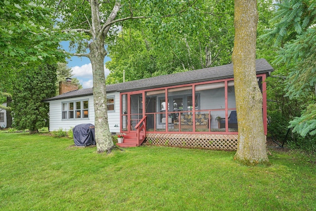 1671 Little Butternut Lake Ln, Luck, WI 54853 - rear view of property with a chimney, a yard, a sunroom, and a shingled roof