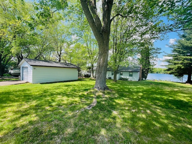1671 Little Butternut Lake Ln, Luck, WI 54853 - view of grassy yard with a water view, an outdoor structure, and a garage