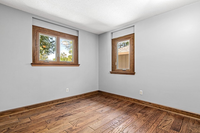 6230 Elm Ridge Cir, Corcoran, MN 55340 - spare room with hardwood / wood-style floors and a textured ceiling
