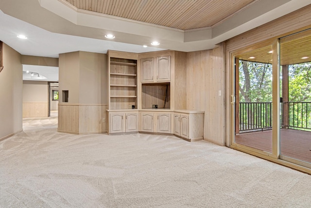 6230 Elm Ridge Cir, Corcoran, MN 55340 - unfurnished living room featuring light carpet, wood walls, recessed lighting, a wainscoted wall, and a raised ceiling
