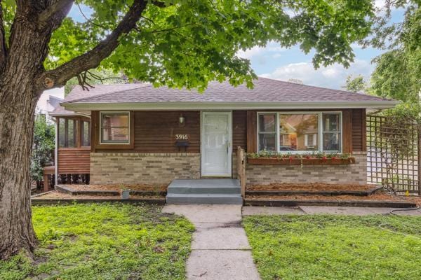 3916 Thomas Ave S, Minneapolis, MN 55410 - view of front facade with brick siding, roof with shingles, and a front lawn