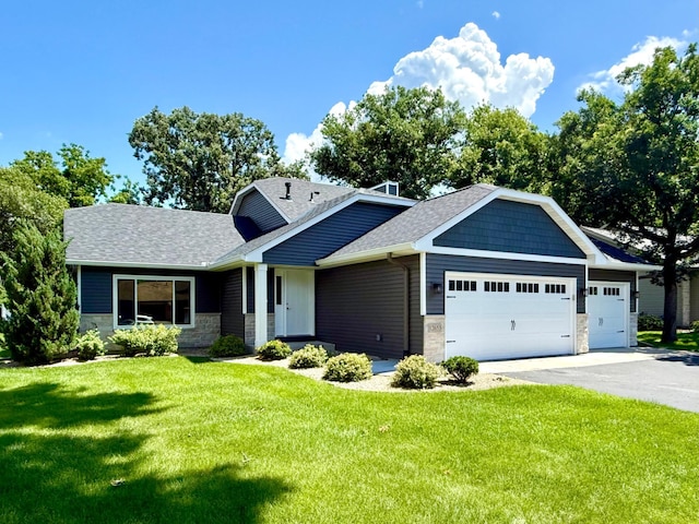 12653 Hastings St NE, Blaine, MN 55449 - view of front of property with a garage, stone siding, asphalt driveway, and a front lawn