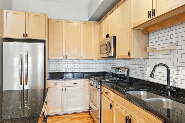 445 Wacouta St Unit 306, Saint Paul, MN 55101 - kitchen with stainless steel appliances, light brown cabinetry, dark stone countertops, and tasteful backsplash