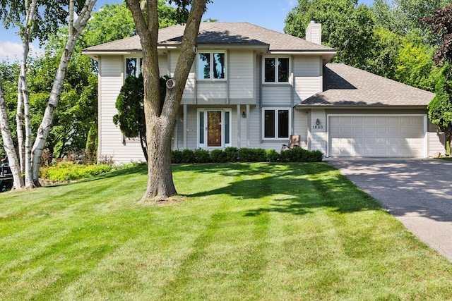 1890 Partridge Cir, Chanhassen, MN 55331 - view of front of house with asphalt driveway, a garage, a chimney, a front lawn, and roof with shingles