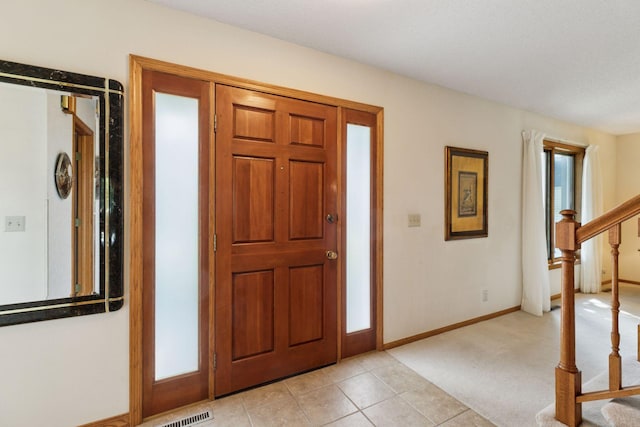 1890 Partridge Cir, Chanhassen, MN 55331 - foyer featuring stairway, light tile patterned floors, and light colored carpet