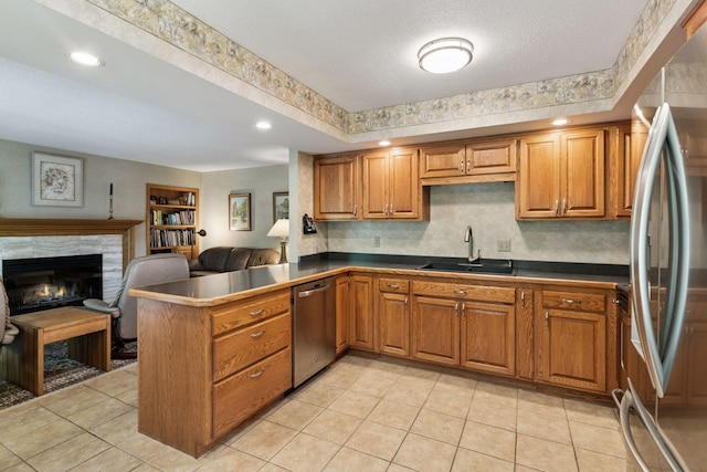 1890 Partridge Cir, Chanhassen, MN 55331 - kitchen featuring appliances with stainless steel finishes, brown cabinets, dark countertops, a fireplace, and recessed lighting