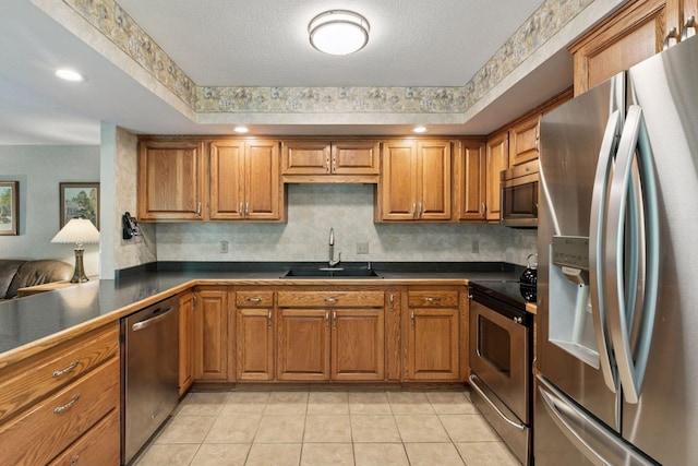 1890 Partridge Cir, Chanhassen, MN 55331 - kitchen with stainless steel appliances, brown cabinets, dark countertops, light tile patterned flooring, and tasteful backsplash