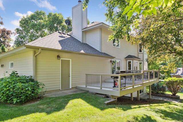 1890 Partridge Cir, Chanhassen, MN 55331 - rear view of house with a shingled roof, a wooden deck, a lawn, and a chimney