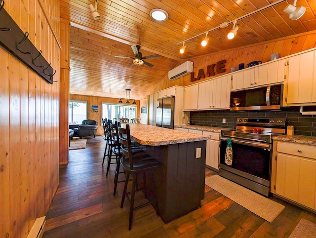 38382 Eldorado Beach Rd, Amor Twp, MN 56515 - kitchen featuring appliances with stainless steel finishes, a wall mounted air conditioner, wood ceiling, light countertops, and vaulted ceiling