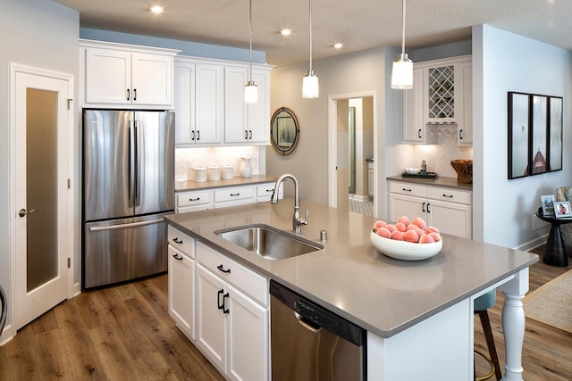 1251 149th St W, Rosemount, MN 55068 - kitchen with appliances with stainless steel finishes, dark wood finished floors, backsplash, white cabinets, and recessed lighting