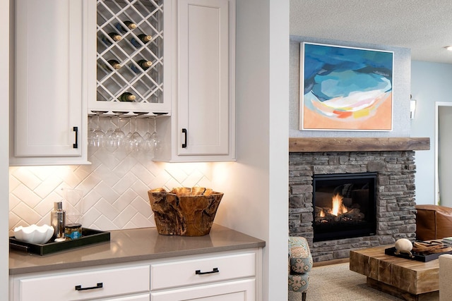 1251 149th St W, Rosemount, MN 55068 - indoor dry bar featuring a stone fireplace and decorative backsplash