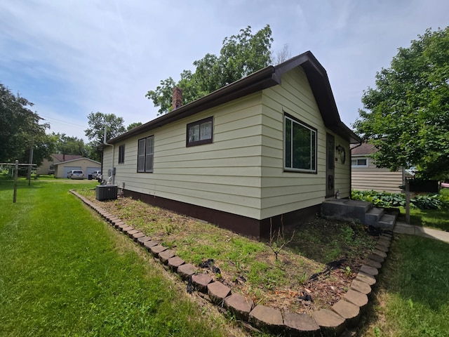 108 9th St, Morris, MN 56267 - view of home's exterior with a lawn and a chimney