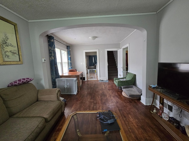 108 9th St, Morris, MN 56267 - living room with arched walkways, a textured ceiling, wood finished floors, stairs, and crown molding