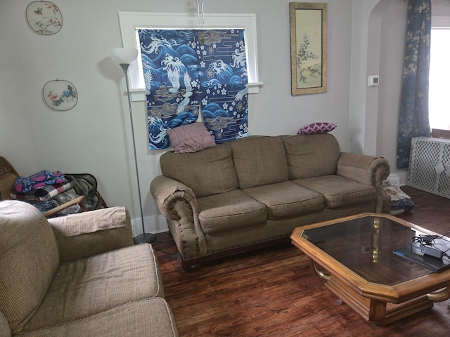 108 9th St, Morris, MN 56267 - living area with dark wood-style flooring, arched walkways, and radiator heating unit