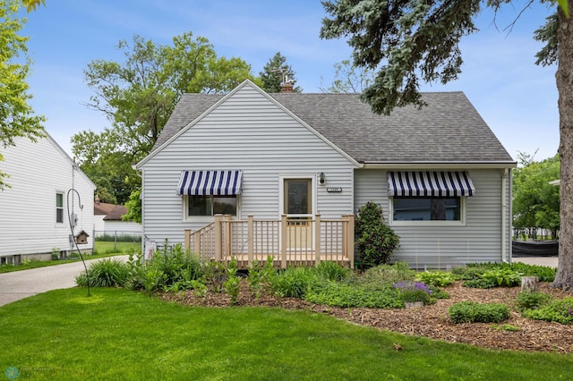 1109 14th St N, Moorhead, MN 56560 - rear view of house with a shingled roof, a lawn, a chimney, and a wooden deck