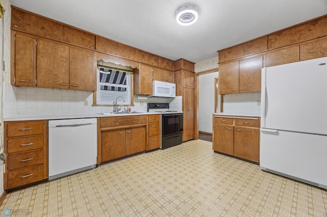 1109 14th St N, Moorhead, MN 56560 - kitchen featuring white appliances, light countertops, brown cabinets, light flooring, and backsplash