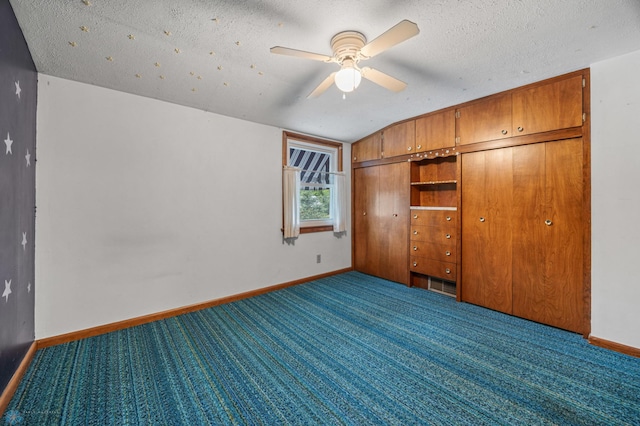 1109 14th St N, Moorhead, MN 56560 - unfurnished bedroom with carpet flooring, a textured ceiling, vaulted ceiling, a closet, and ceiling fan