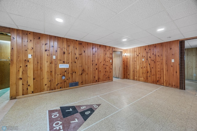 1109 14th St N, Moorhead, MN 56560 - finished below grade area featuring tile patterned floors, wood walls, recessed lighting, and a paneled ceiling
