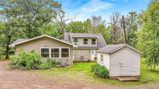 14645 Chapel Rd, Edgewater, WI 54817 - rear view of property with a shed, a lawn, roof with shingles, and view of wooded area