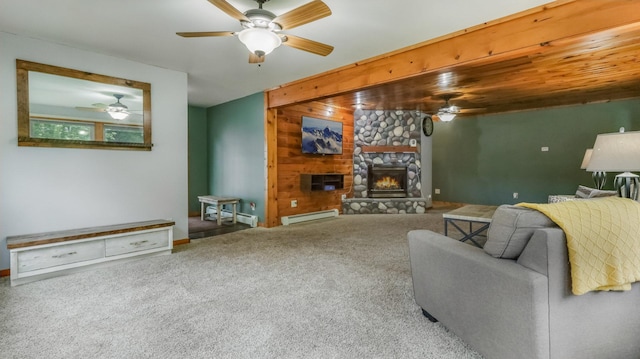 14645 Chapel Rd, Edgewater, WI 54817 - living room featuring a ceiling fan, baseboard heating, a fireplace, carpet floors, and wood walls