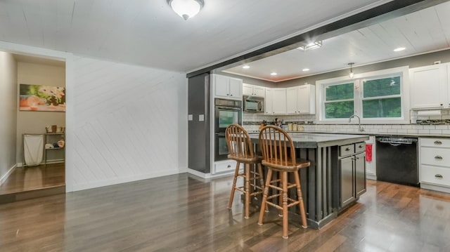 14645 Chapel Rd, Edgewater, WI 54817 - kitchen with appliances with stainless steel finishes, decorative backsplash, a breakfast bar area, dark wood-style floors, and white cabinetry