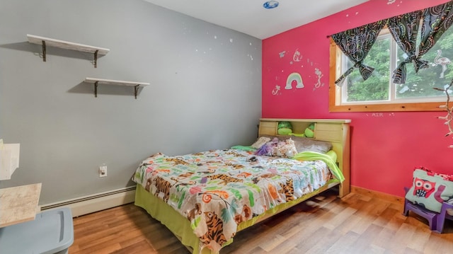 14645 Chapel Rd, Edgewater, WI 54817 - bedroom featuring a baseboard heating unit and wood finished floors