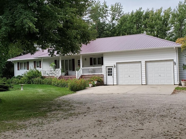 26233 555th Ave, Lansing Twp, MN 55912 - single story home featuring covered porch, a garage, a metal roof, and concrete driveway