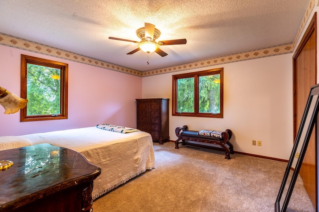 26233 555th Ave, Lansing Twp, MN 55912 - bedroom with multiple windows, light colored carpet, a textured ceiling, and ceiling fan