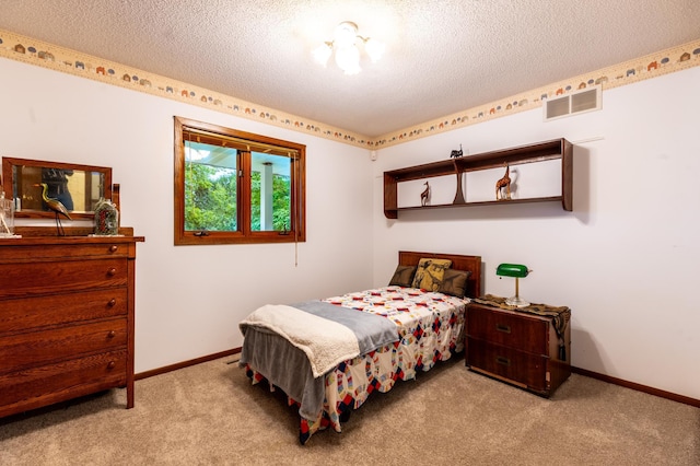 26233 555th Ave, Lansing Twp, MN 55912 - carpeted bedroom with a textured ceiling and baseboards