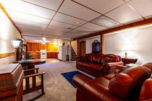 26233 555th Ave, Lansing Twp, MN 55912 - living room featuring a paneled ceiling, wooden walls, light carpet, and stairway