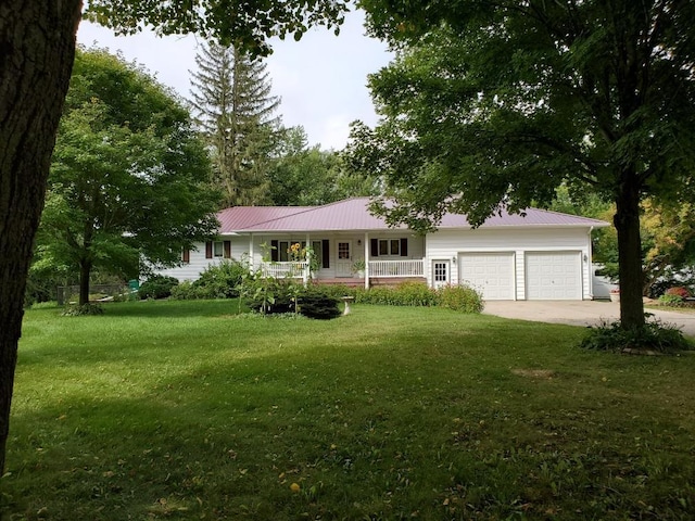 26233 555th Ave, Lansing Twp, MN 55912 - ranch-style house featuring a porch, an attached garage, a front lawn, a metal roof, and driveway