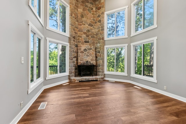 27088 130th St, Staples, MN 56479 - unfurnished living room with a towering ceiling, wood finished floors, and a fireplace