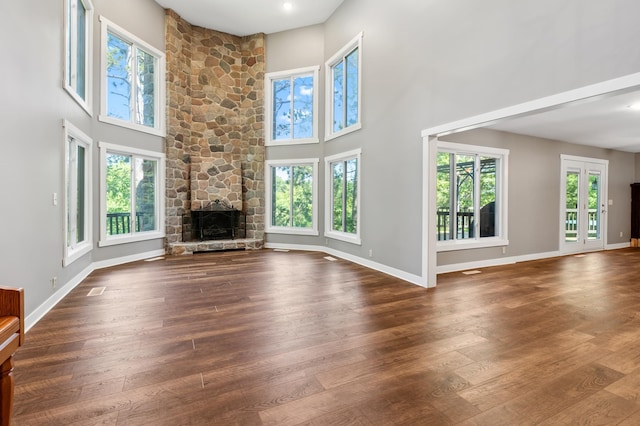 27088 130th St, Staples, MN 56479 - unfurnished living room with dark wood finished floors, a high ceiling, and a fireplace