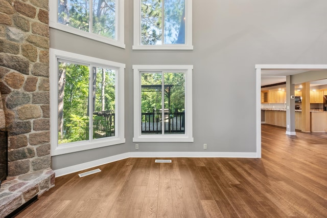 27088 130th St, Staples, MN 56479 - unfurnished living room featuring a towering ceiling and wood finished floors