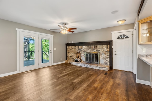 27088 130th St, Staples, MN 56479 - unfurnished living room with ceiling fan, wood finished floors, and a brick fireplace