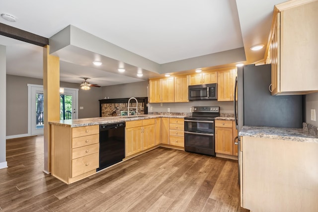 27088 130th St, Staples, MN 56479 - kitchen featuring stainless steel microwave, dishwasher, double oven range, light brown cabinets, and a peninsula