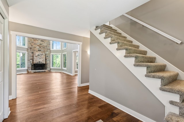 27088 130th St, Staples, MN 56479 - stairway with wood finished floors, plenty of natural light, and a stone fireplace
