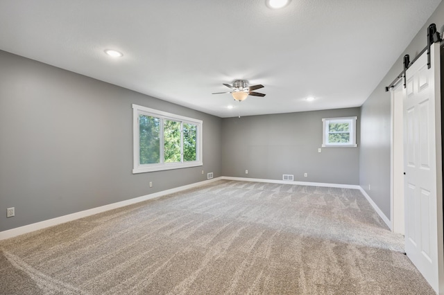 27088 130th St, Staples, MN 56479 - carpeted spare room featuring a barn door, ceiling fan, and recessed lighting