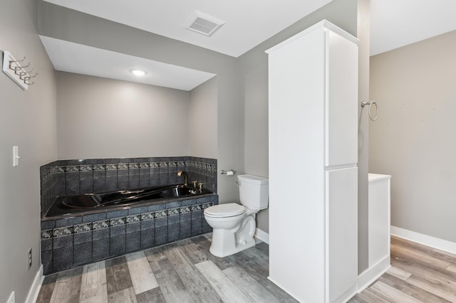 27088 130th St, Staples, MN 56479 - bathroom featuring a garden tub and wood finished floors
