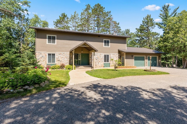 27088 130th St, Staples, MN 56479 - view of front facade with stone siding, a garage, a front lawn, and driveway